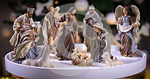 Jesus Christ Nativity scene in front of Christmas tree lights
