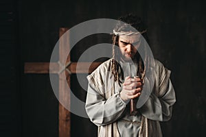 Jesus Christ praying with bible in hands