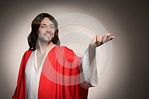 Jesus Christ reaching out his hand on beige background