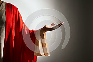 Jesus Christ reaching out his hand on grey background, closeup view