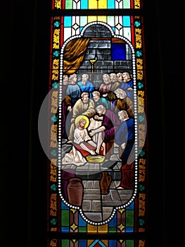 Jesus Christ washing the feet of his disciples in a stained glass window in the Cathedral of the Assumption. Bangkok