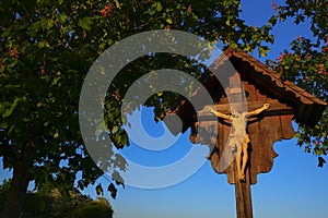 Jesus Christ on the wood cross in blooming chestnut trees .Christian and catholic faith symbol.Religious symbol.Easter