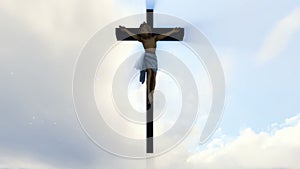 Jesus cross against heavenly white sky with pigeons flying