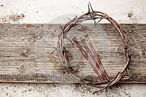 Jesus Crown Thorns and nails on Old and Grunge Wood Background. Vintage Retro Style.