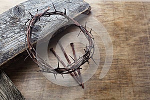 Jesus Crown Thorns and nails on Old and Grunge Wood Background. Vintage Retro Style.