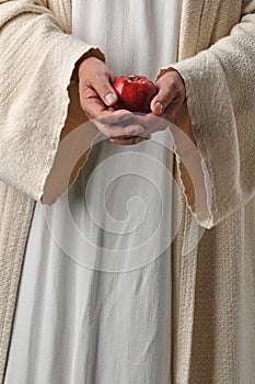 Jesus hands holding an apple