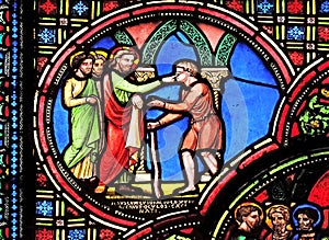 Jesus heals a blind man, stained glass window from Saint Germain-l`Auxerrois church in Paris photo