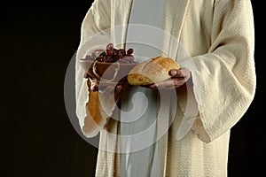 Jesus Holding bresd and grapes