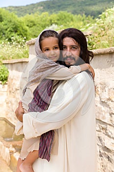 Jesus holding a little girl