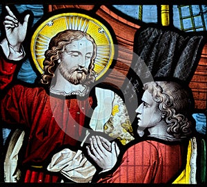 Jesus pointing to heaven. Stained glass window iconography