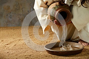 Jesus pouring water from a jar photo