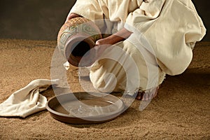 Jesus pouring water from a jar photo