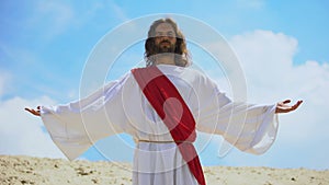 Jesus raising arms to sky, bringing blessing and faith, Christian religion