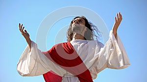 Jesus raising hands to sky and praying, resurrection and ascension of Christ