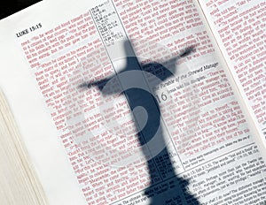 Jesus shadow on red letter Bible with Luke photo