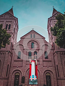 Old historical church picture and Jesus Christ statue in front with blue sky