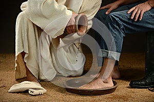 Jesus Washing Feet of Man in Jeans