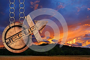 Jesus Wooden Symbol with Cross at the Sunset