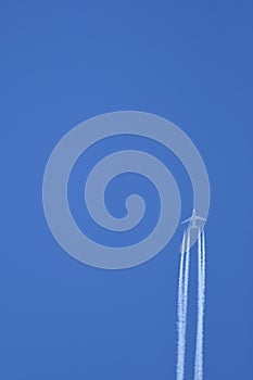 Jet aircraft in flight leaving vapour trails