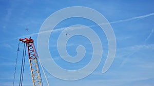 Jet airliner and a helicopter appear to fly near one another in blue skies over London, England