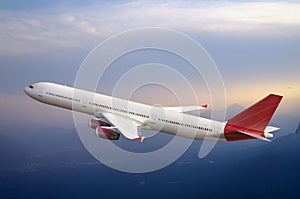 Jet airplane flying in the sky above mountains