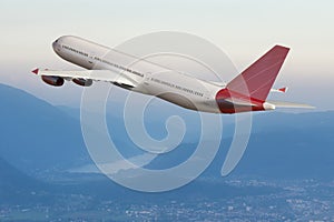 Jet airplane flying in the sky, above mountains