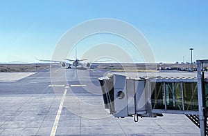 Jet bridge with Aircraft driving by the runway before airplane takeoff. Airways and transportation concept image at Addis Ababa photo