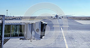 Jet bridge with Aircraft driving by the runway before airplane takeoff. Airways and transportation concept image at Addis Ababa