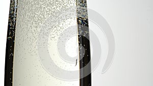 Jet Of Champagne Of Carbonated Drink Or An Alcoholic Cocktail Is Poured Into Glass On A White Background.