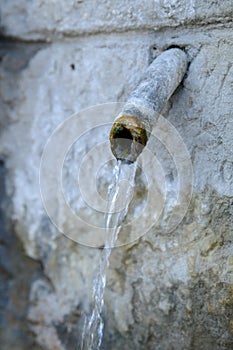 Jet and crystal clear water lapping in trough or fountain. Gurgl