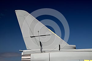 Jet Fighter Aircraft Tail Section Against a Clear Blue Sky