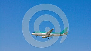 Jet passenger airplane flying with blue sky background.