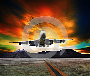 Jet plane flying over runways and beautiful dusky sky with copy