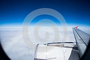 Jet plane flying over white cloud and clear blue sky above