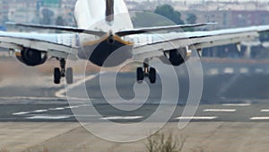 Jet plane landing with smoke on runway