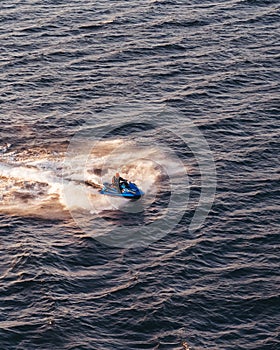 Jet ski going fast in the waters of the Stockholm archipelago at the sunset, Sweden