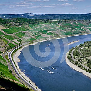 Jet ski\'s speed around a curve in the Rhine River as seen from a nearby mountain top