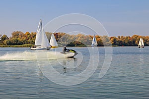 Jet ski and sailboats sailing on the Dnieper river in Kremenchug, Ukraine