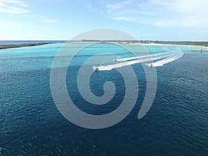 Jet skis traveling near an island in the Bahamas