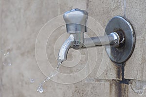 A jet of water flows from a faucet, plumbing repair. Water scarcity