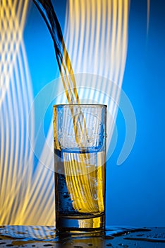 A jet of water pours into the glass