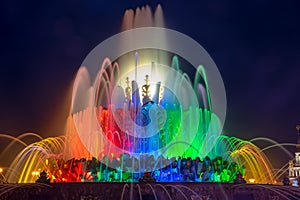 The jets of the beautiful unusual fountain `stone flower` frozen on a long exposure in the rays of the evening bright and colorful