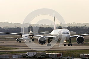 Jets lined up at a busy airport photo