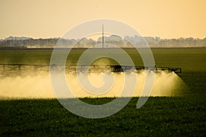 Jets of liquid fertilizer from the tractor sprayer