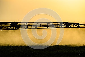 Jets of liquid fertilizer from the tractor sprayer