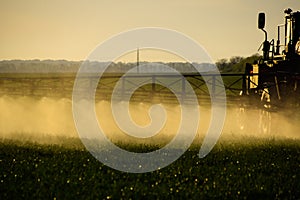 Jets of liquid fertilizer from the tractor sprayer