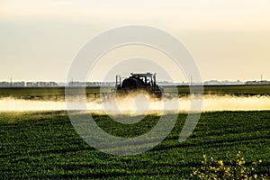 Jets of liquid fertilizer from the tractor sprayer