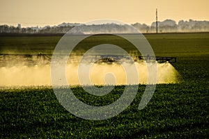 Jets of liquid fertilizer from the tractor sprayer