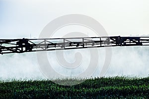 Jets of liquid fertilizer from the tractor sprayer