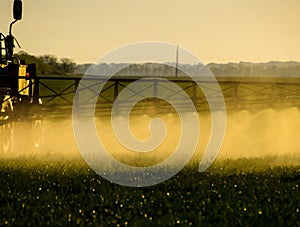 Jets of liquid fertilizer from the tractor sprayer